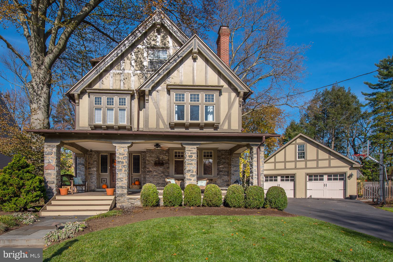 a front view of a house with a yard and green space