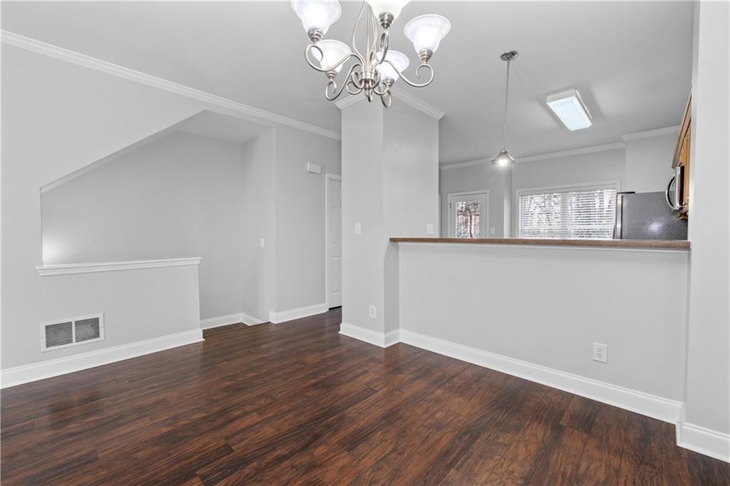 3072 Lauren Parc Road Decatur, GA 30032 - Photo 14 of 36 a view of a room with wooden floor and chandelier