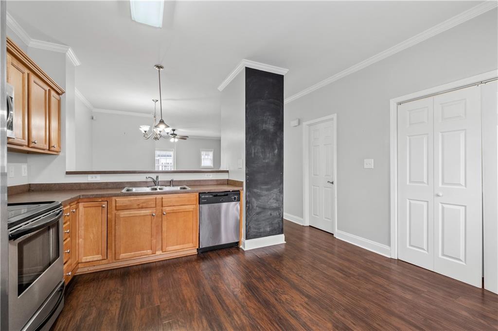 3072 Lauren Parc Road Decatur, GA 30032 - Photo 17 of 36 a large kitchen with stainless steel appliances granite countertop a stove a sink and a wooden floors
