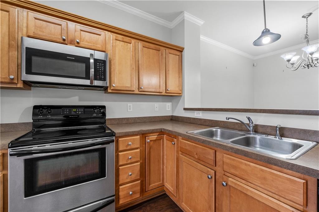 3072 Lauren Parc Road Decatur, GA 30032 - Photo 18 of 36 a kitchen with granite countertop a sink stove and microwave