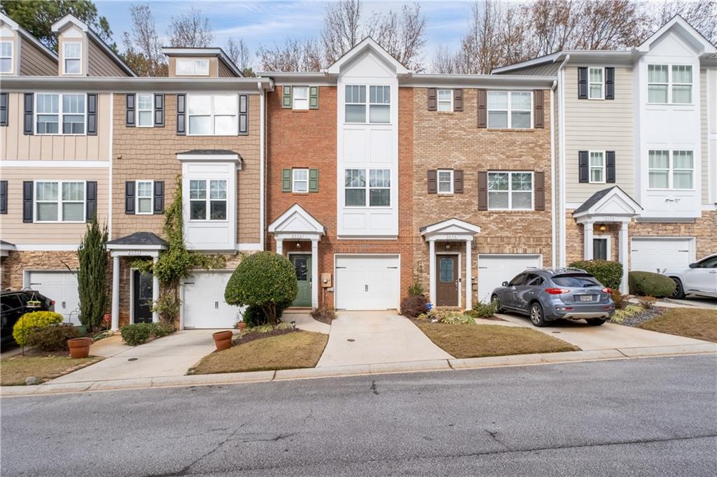 3072 Lauren Parc Road Decatur, GA 30032 - Photo 2 of 36 a front view of a residential apartment building with a yard and parking space