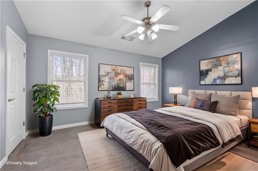 3072 Lauren Parc Road Decatur, GA 30032 - Photo 30 of 36 a spacious bedroom with a balcony a bed and a chandelier