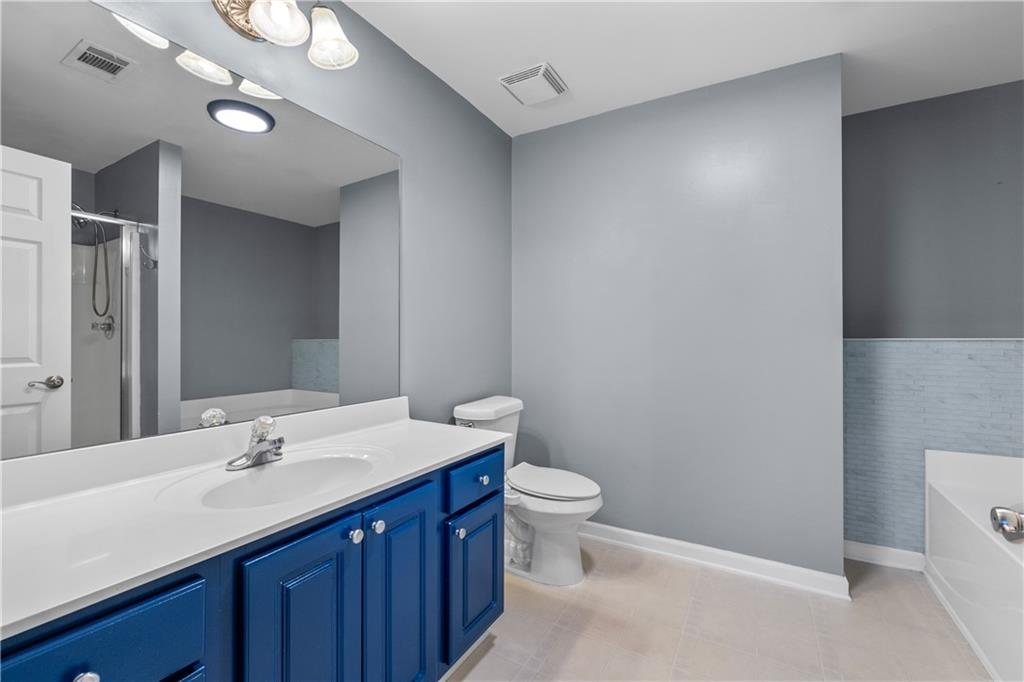 3072 Lauren Parc Road Decatur, GA 30032 - Photo 33 of 36 a bathroom with a sink and a mirror
