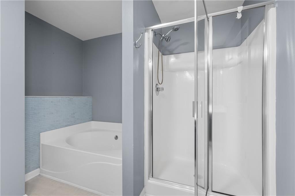 3072 Lauren Parc Road Decatur, GA 30032 - Photo 34 of 36 a bathroom with a bathtub and a shower