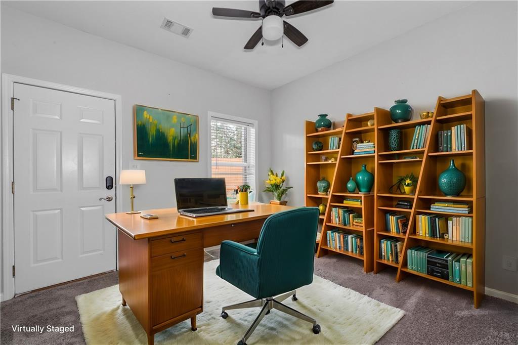 3072 Lauren Parc Road Decatur, GA 30032 - Photo 7 of 36 a view of a workspace with furniture and a bookshelf