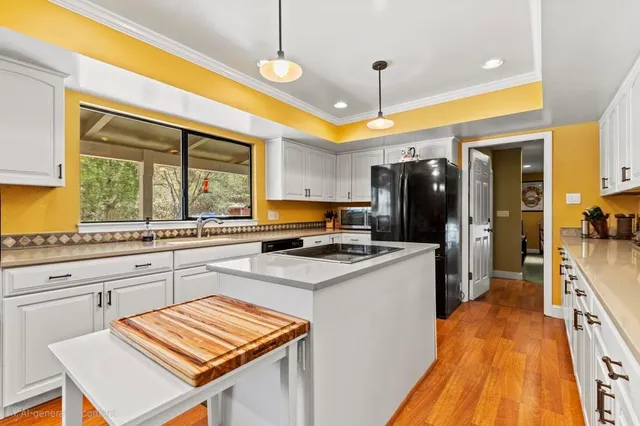 a kitchen with lots of counter space a sink appliances and a dining table