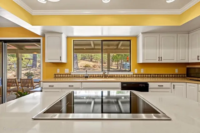 a room with stainless steel appliances lots of counter space and wooden floor