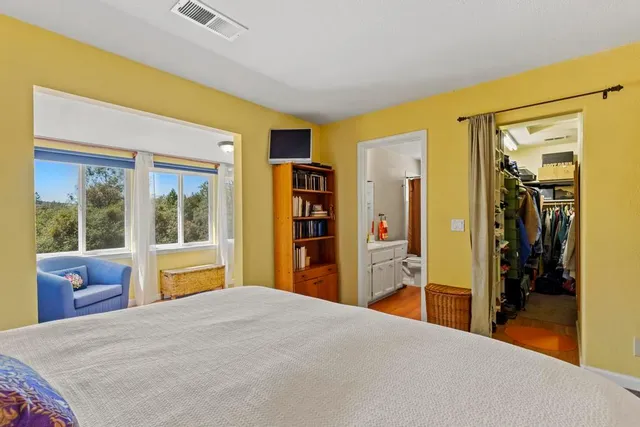 a bedroom with a bed and a view of bedroom