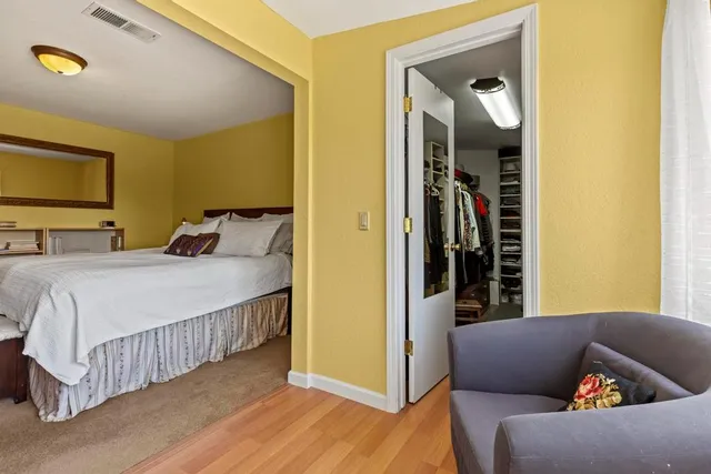 a view of walk in closet with clothes