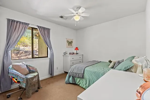 a bedroom with a bed dresser and a window