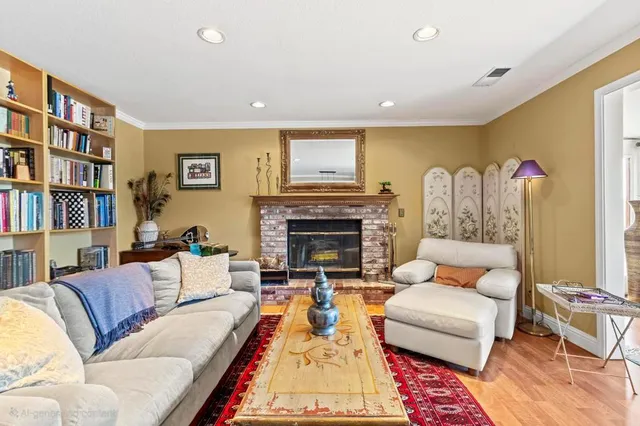 a living room with furniture a rug and a flat screen tv