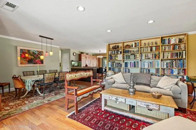 a living room with furniture a rug and a flat screen tv