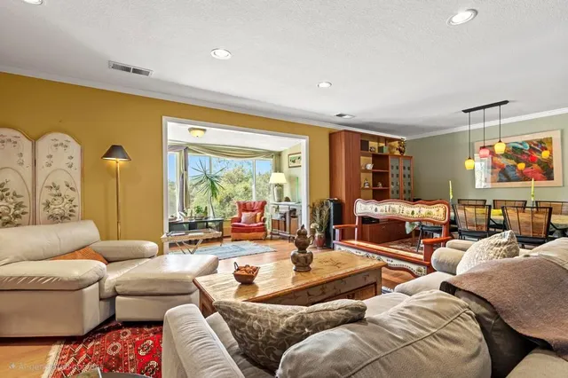 a living room with furniture large windows and a rug