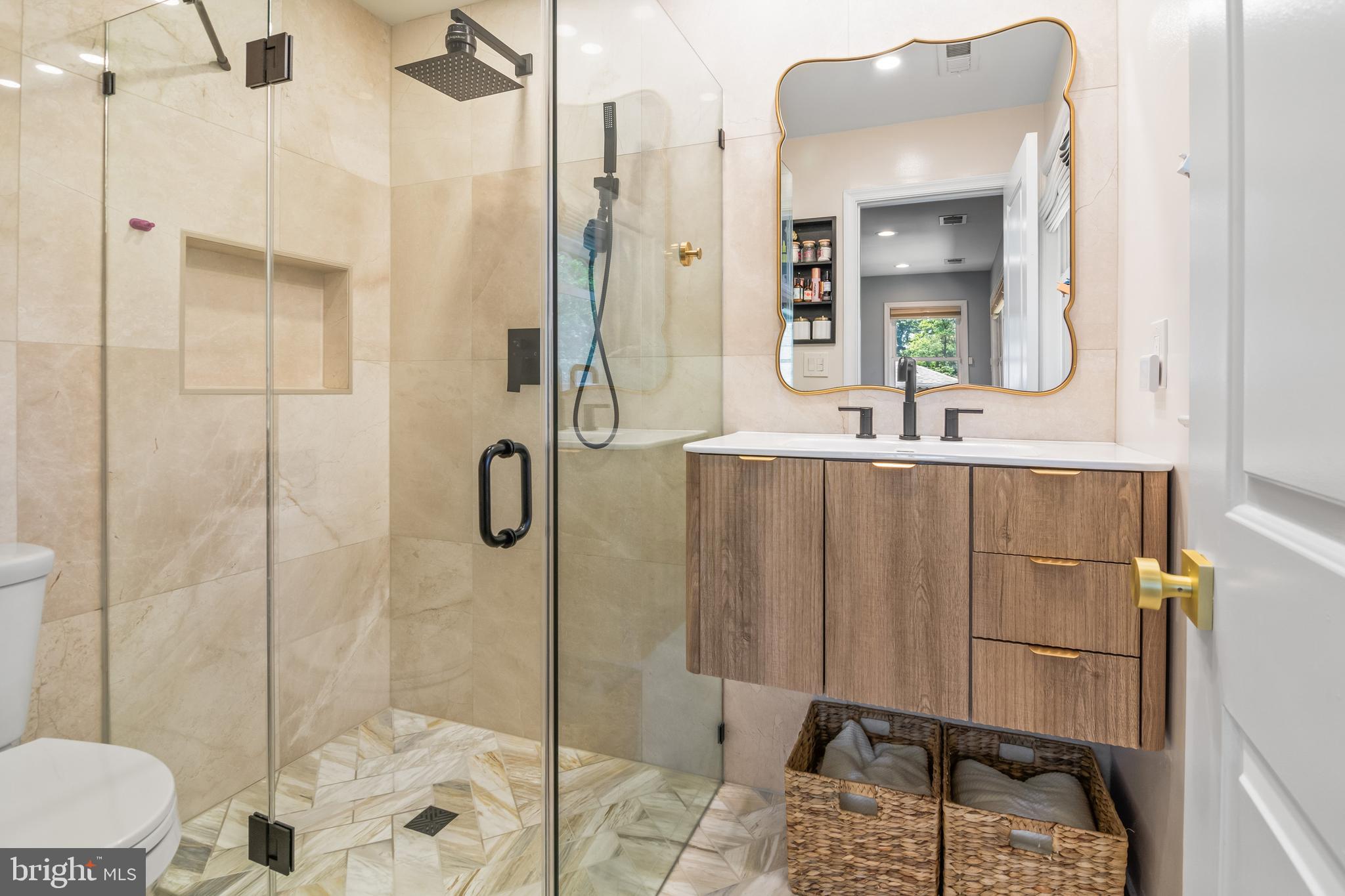 6308 Ivymount Road Baltimore, MD 21209 - Photo 11 of 22 a bathroom with a shower a mirror and a sink