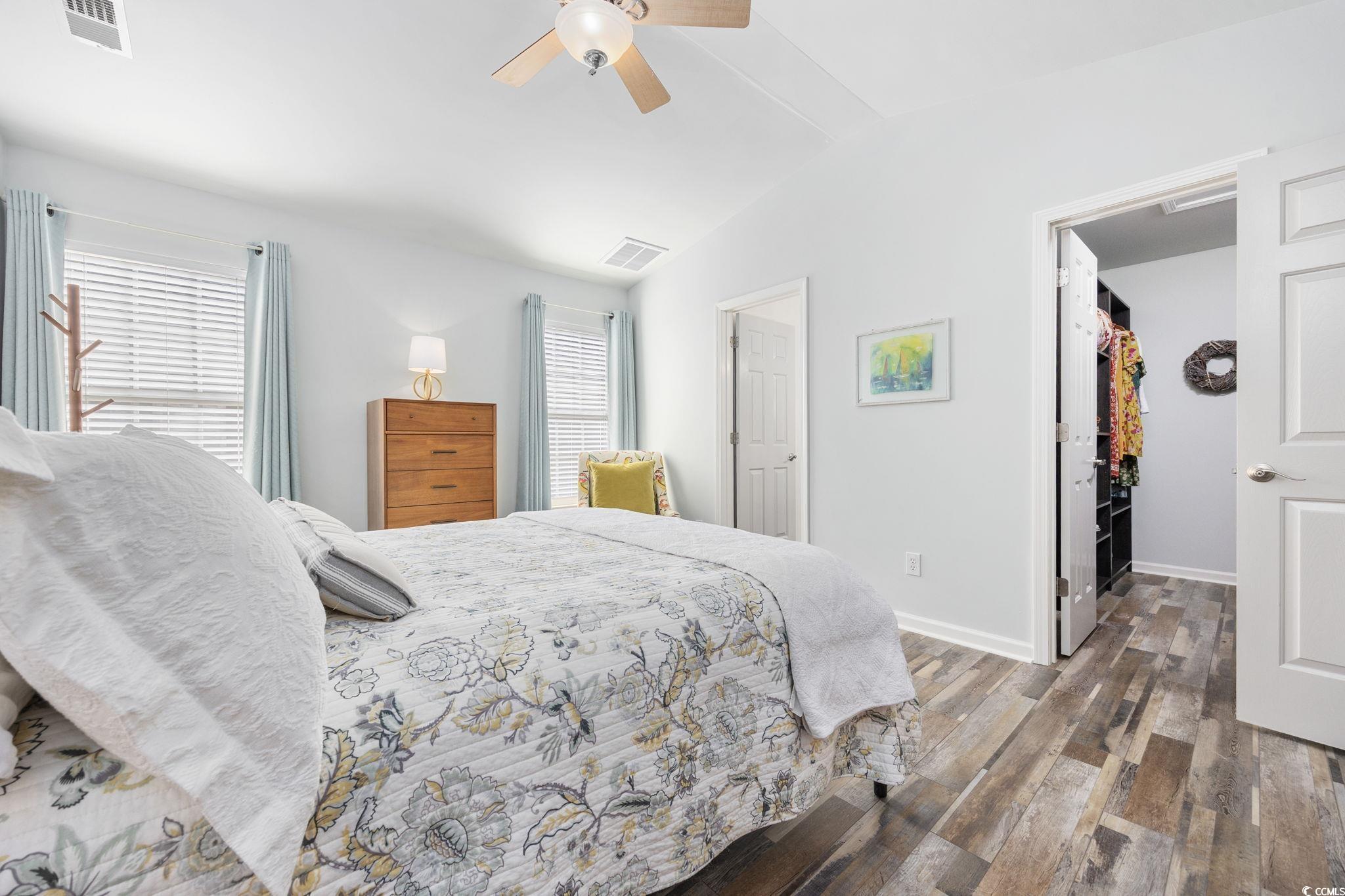 4618 Fringetree Drive Murrells Inlet, SC 29576 - Photo 13 of 40 Bedroom featuring wood finished floors, multiple windows, a spacious closet, lofted ceiling, and a ceiling fan