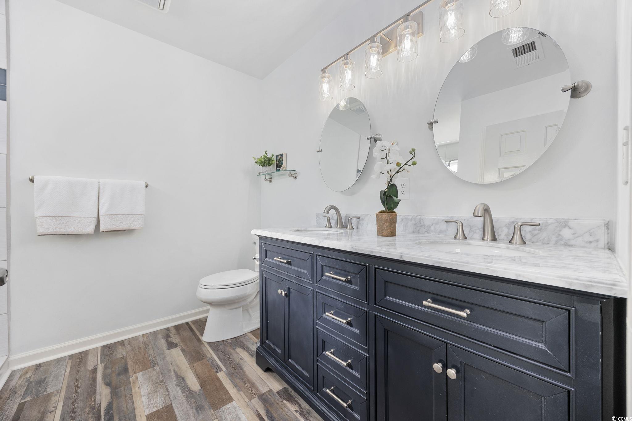 4618 Fringetree Drive Murrells Inlet, SC 29576 - Photo 15 of 40 Bathroom featuring dark wood-style floors and double vanity