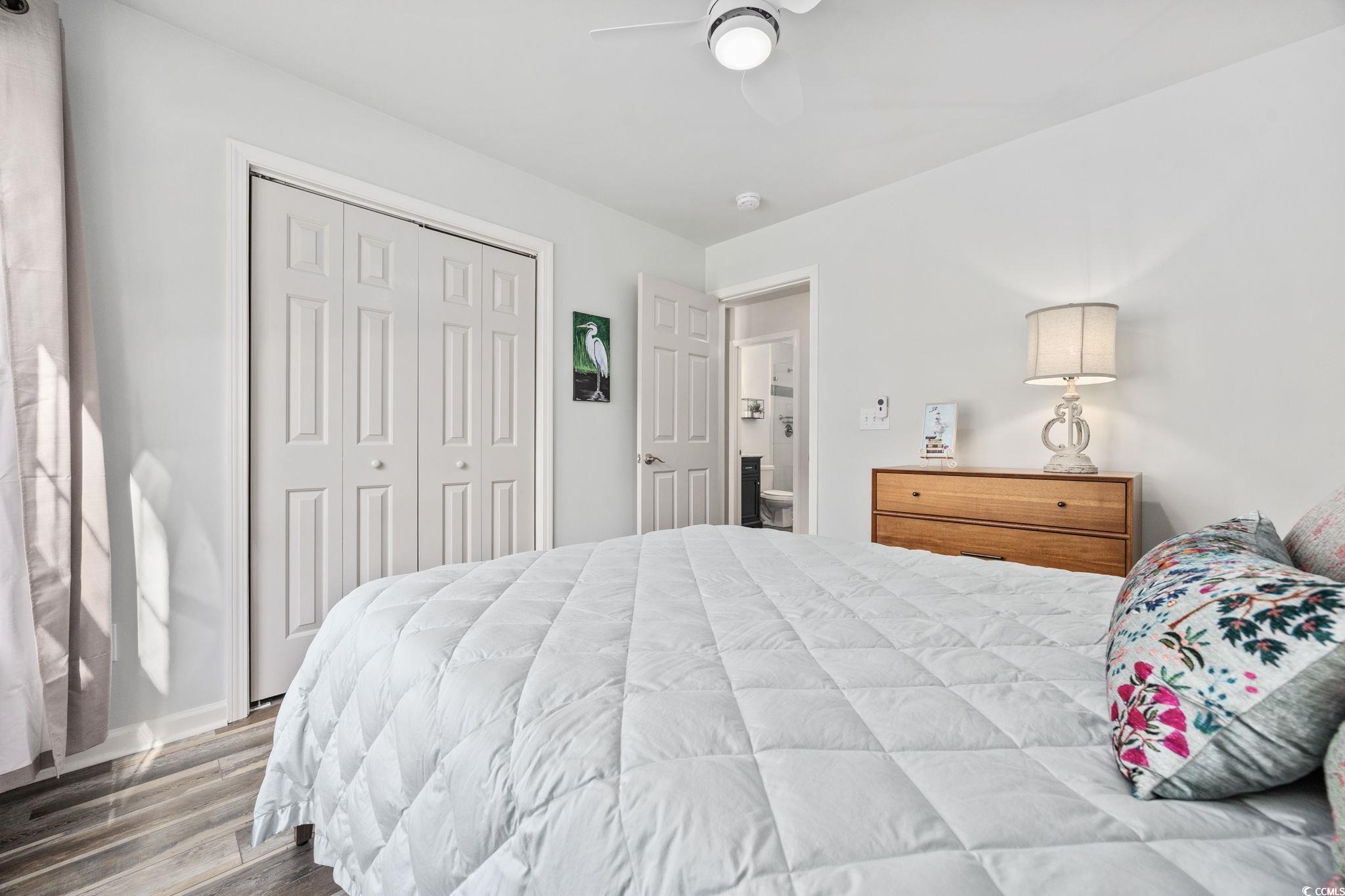 4618 Fringetree Drive Murrells Inlet, SC 29576 - Photo 18 of 40 Bedroom featuring wood finished floors, a closet, and ceiling fan