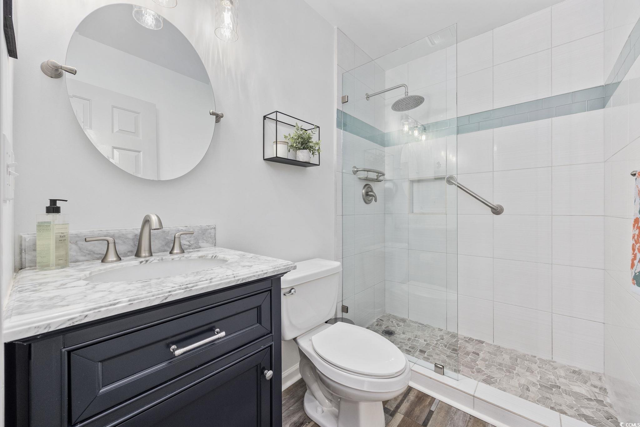 4618 Fringetree Drive Murrells Inlet, SC 29576 - Photo 19 of 40 Bathroom with vanity, a stall shower, and dark wood-type flooring