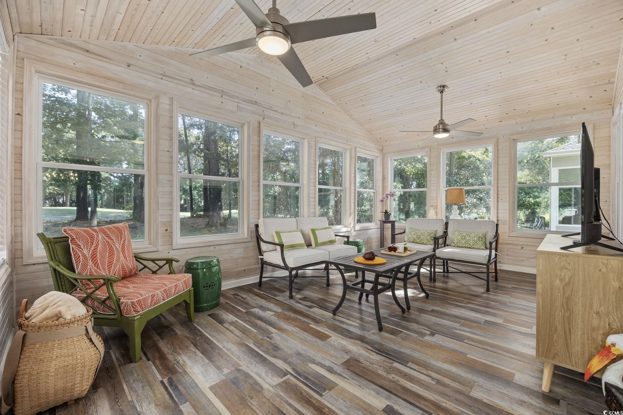 4618 Fringetree Drive Murrells Inlet, SC 29576 - Photo 22 of 40 Sunroom with lofted ceiling, wood finished floors, wood walls, and wood ceiling