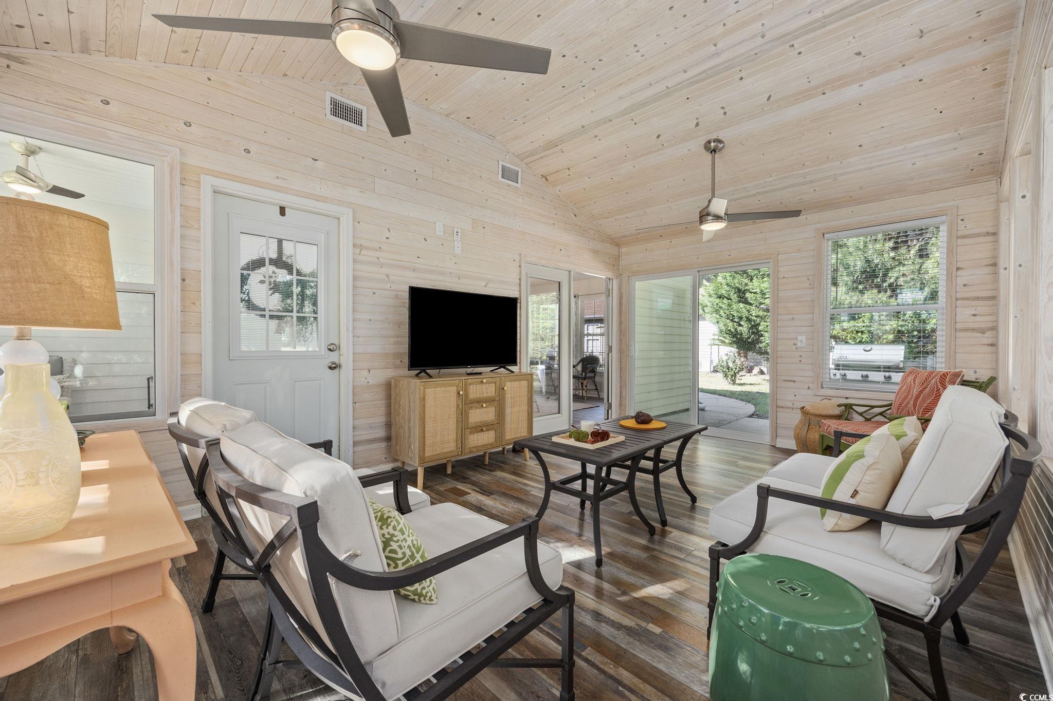 4618 Fringetree Drive Murrells Inlet, SC 29576 - Photo 23 of 40 Living area with wooden walls, dark wood-style flooring, wooden ceiling, plenty of natural light, and high vaulted ceiling