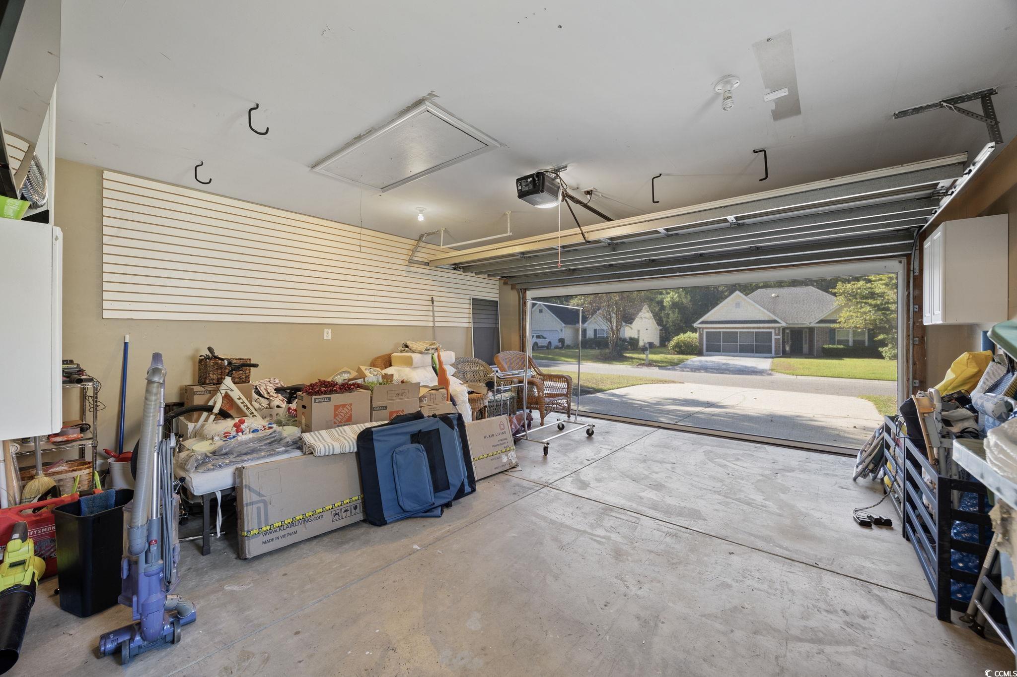 4618 Fringetree Drive Murrells Inlet, SC 29576 - Photo 27 of 40 Garage featuring a garage door opener