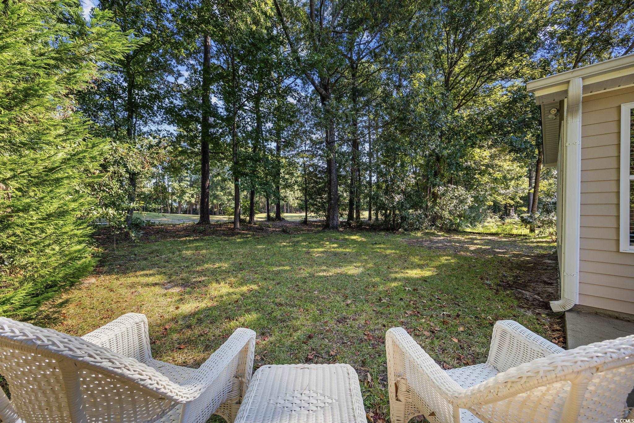 4618 Fringetree Drive Murrells Inlet, SC 29576 - Photo 29 of 40 View of green lawn with view of scattered trees