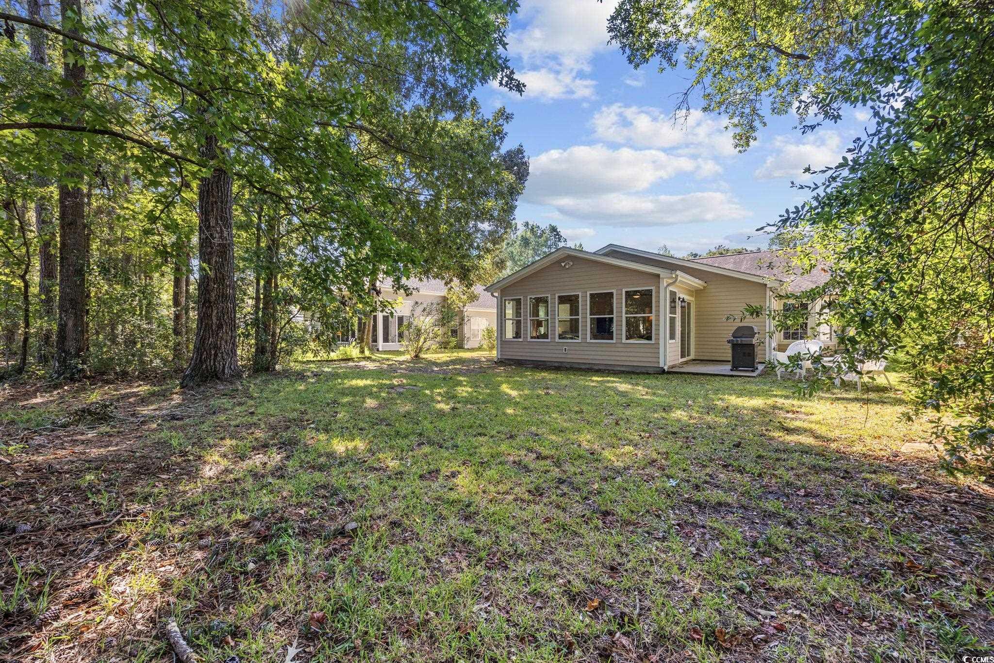 4618 Fringetree Drive Murrells Inlet, SC 29576 - Photo 30 of 40 View of grassy yard with a sunroom and a patio