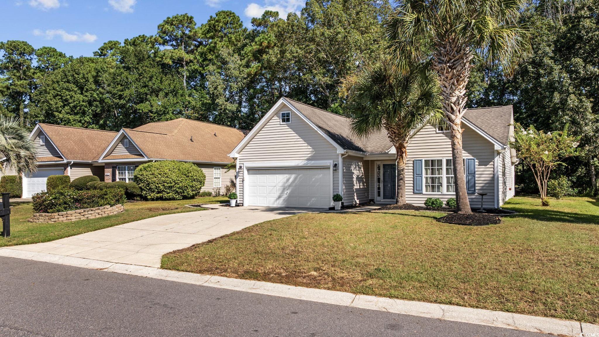 4618 Fringetree Drive Murrells Inlet, SC 29576 - Photo 40 of 40 View of front facade with driveway, a front yard, and an attached garage