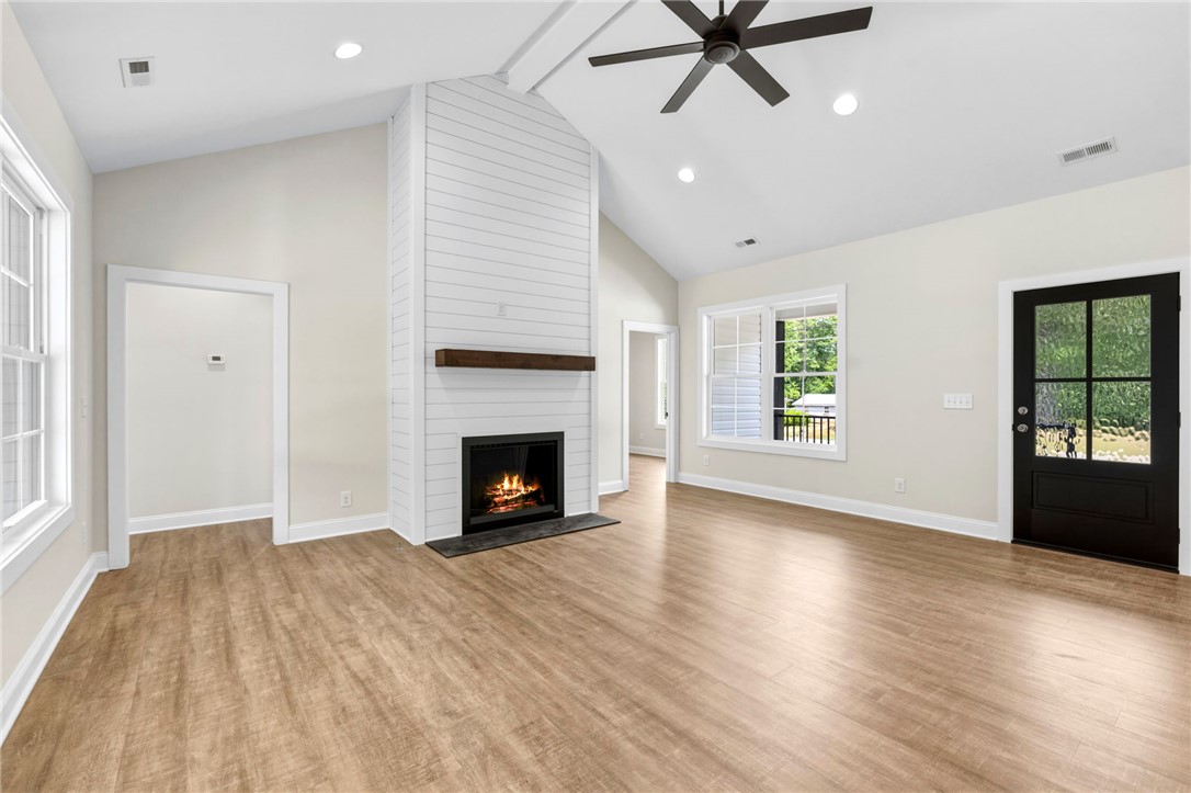1735 Maw Bridge Road Central, SC 29630 - Photo 6 of 38 This bright living space features a cozy fireplace, creating an inviting atmosphere for everyday living.