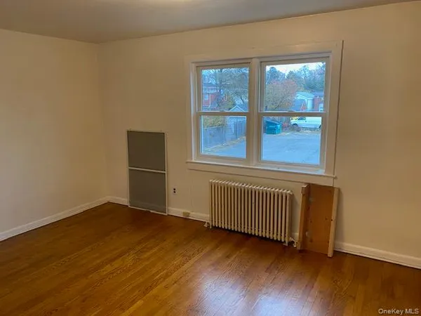 a view of a room with wooden floor