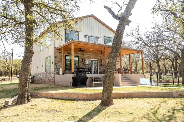a kitchen with stainless steel appliances a stove a refrigerator a sink dishwasher and a oven with wooden floor