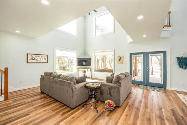 a living room with couches and a dining table with rug