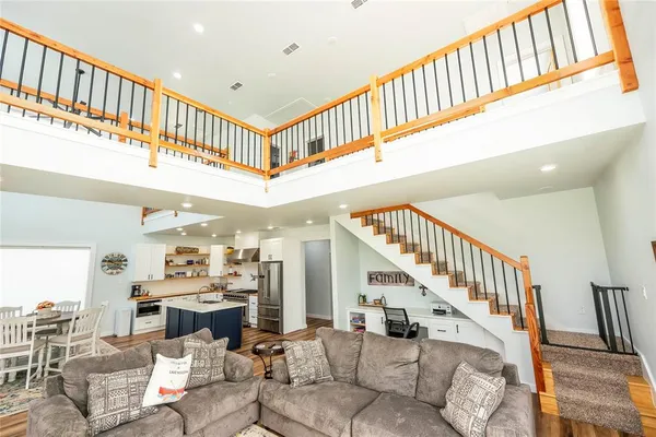 a living room with furniture a large window and flat screen tv