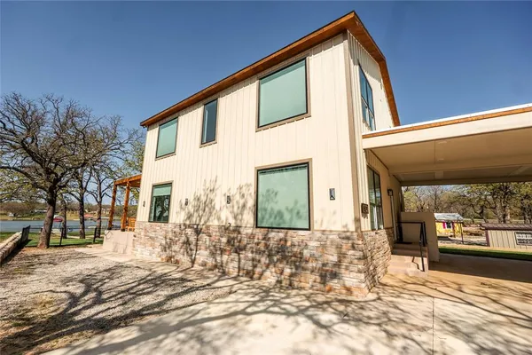 a view of a patio with couches and pool table and chairs under an umbrella