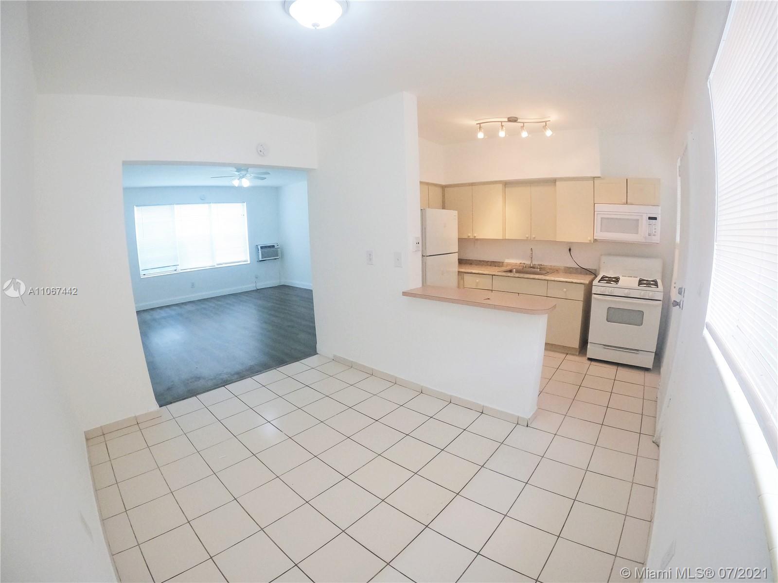 809 85th Street Miami Beach, FL 33141 - Photo 12 of 32 a bathroom with a sink vanity and mirror