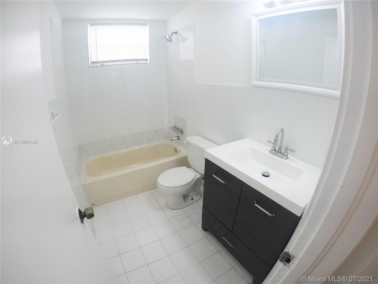809 85th Street Miami Beach, FL 33141 - Photo 23 of 32 a bathroom with a sink a toilet and bathtub