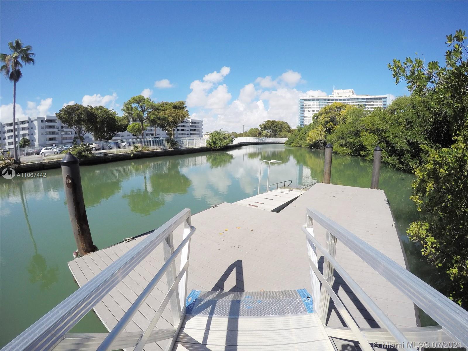 809 85th Street Miami Beach, FL 33141 - Photo 30 of 32 a view of a lake with a house in the background