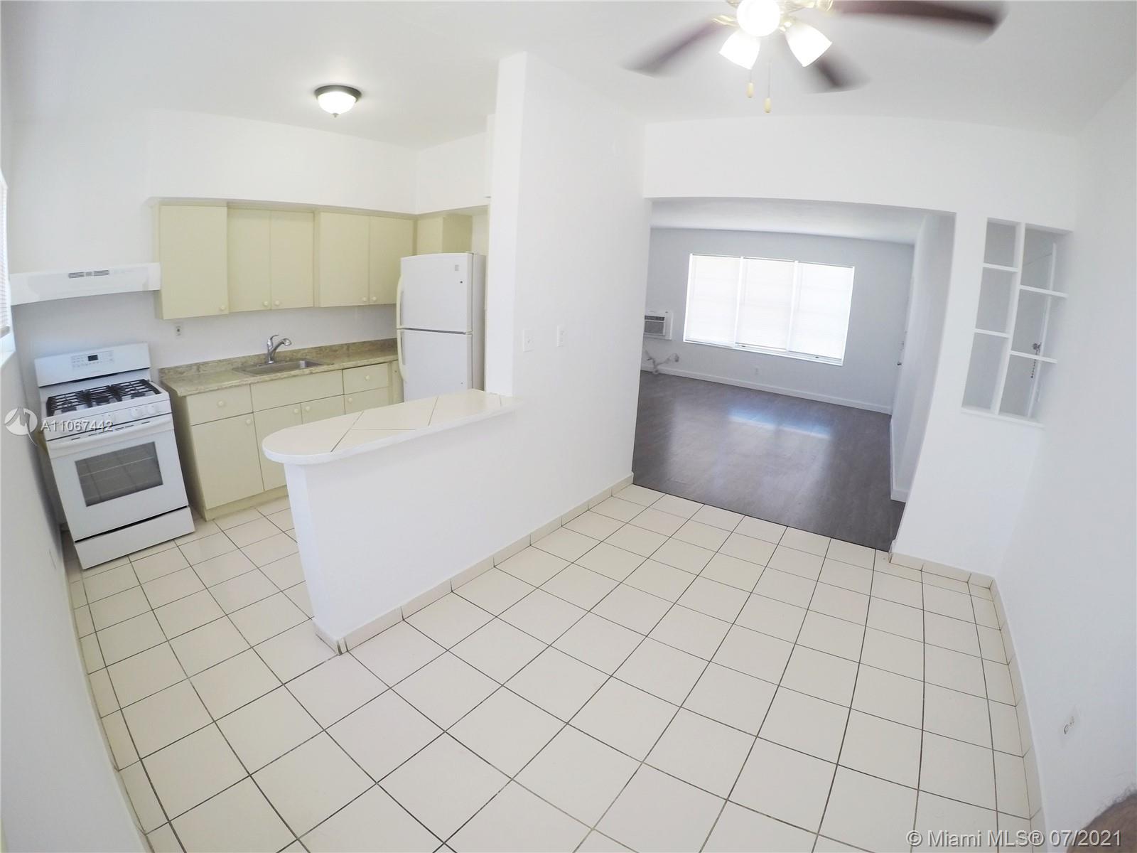 809 85th Street Miami Beach, FL 33141 - Photo 4 of 32 a view of a kitchen with microwave and cabinets