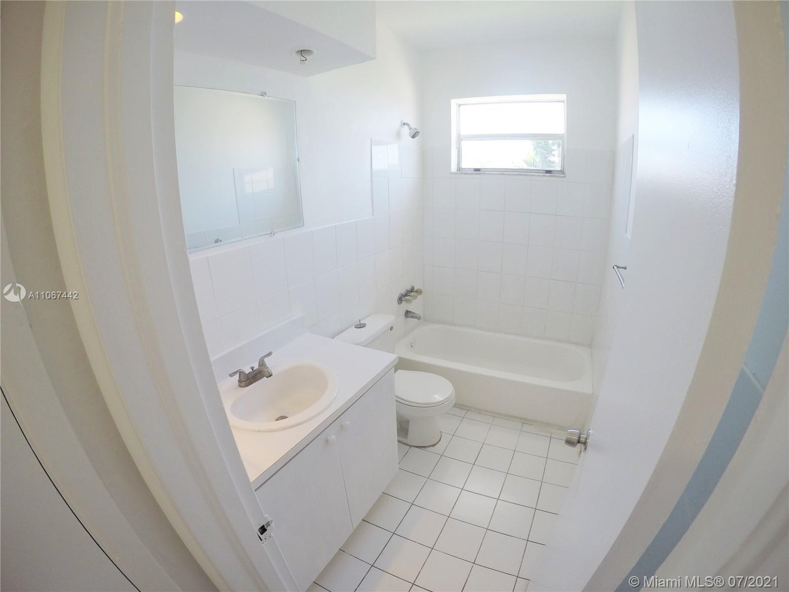 809 85th Street Miami Beach, FL 33141 - Photo 8 of 32 a bathroom with a sink a toilet and shower