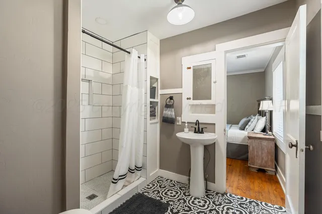 a bathroom with a toilet sink a shower and a mirror