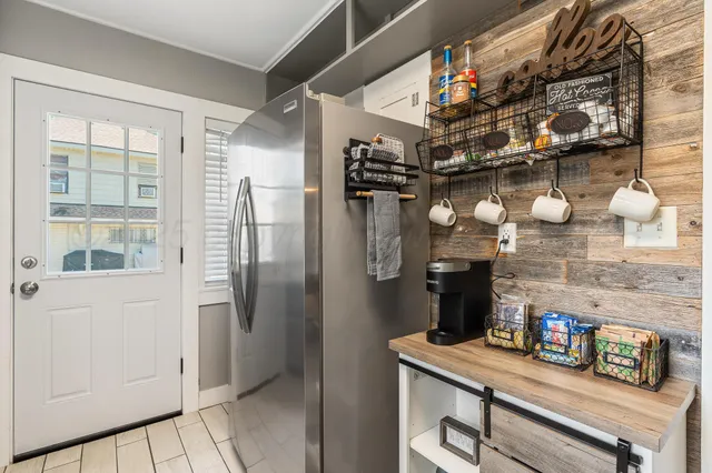 a kitchen with granite countertop stainless steel appliances a sink and a refrigerator