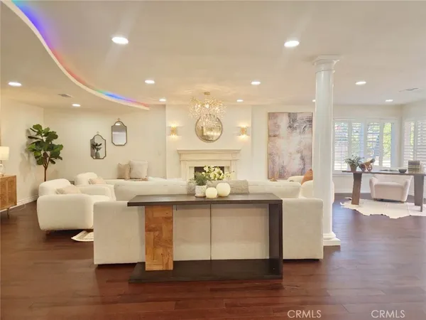 a living room with fireplace furniture and a wooden floor