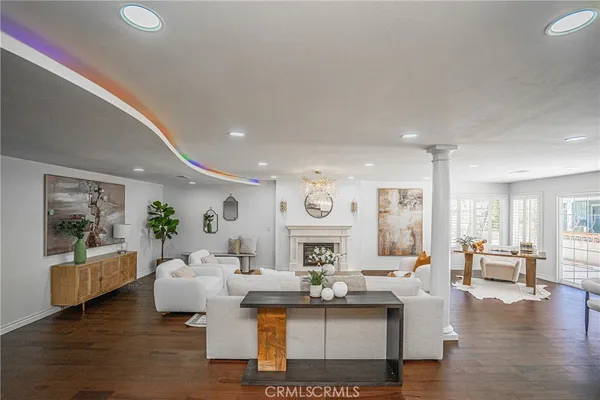 a living room with furniture and wooden floor