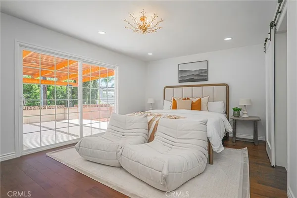 a bedroom with a large bed and a large window