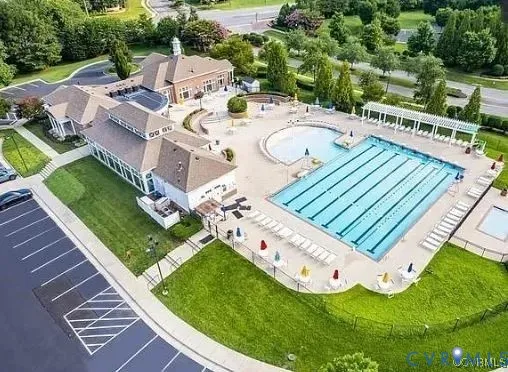 a view of a swimming pool with a patio and a garden