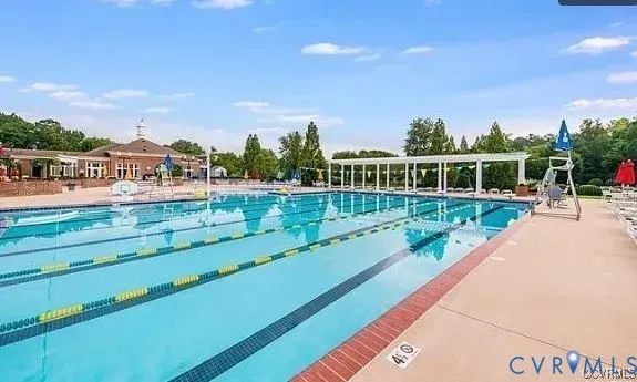 a view of a swimming pool with a garden and trees