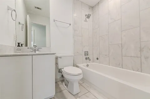 a bathroom with a sink a toilet and a bathtub