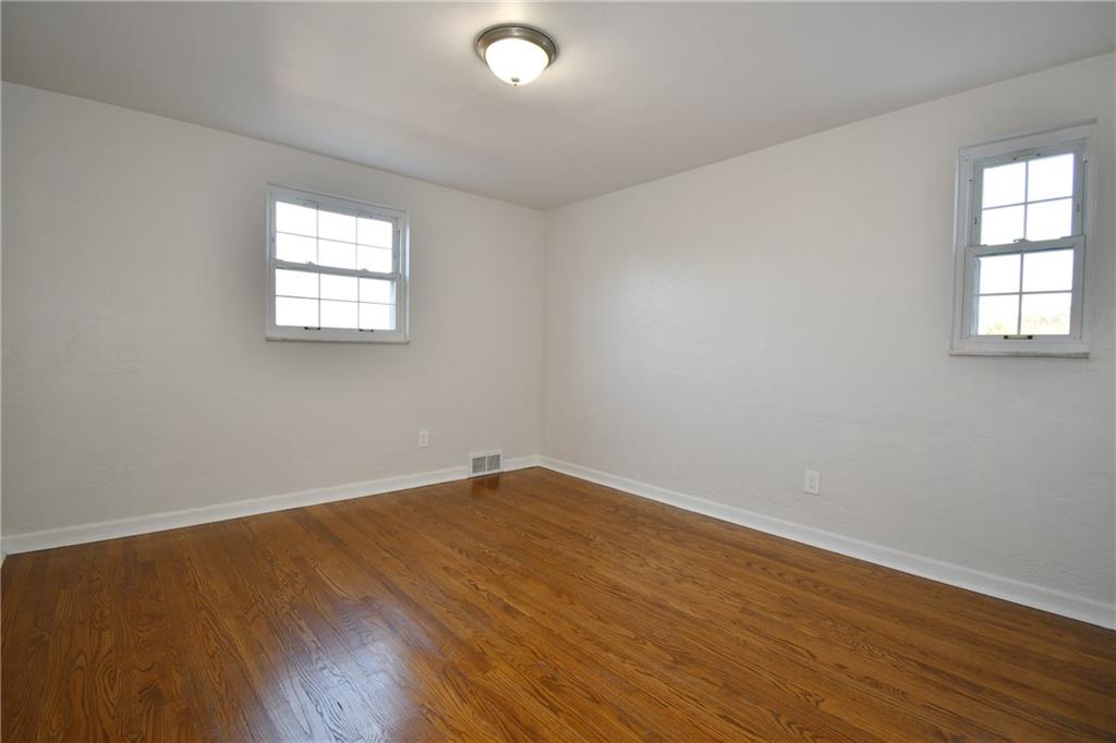 217 Oaklyn Road Bethel Park, PA 15102 - Photo 12 of 42 an empty room with wooden floor and windows