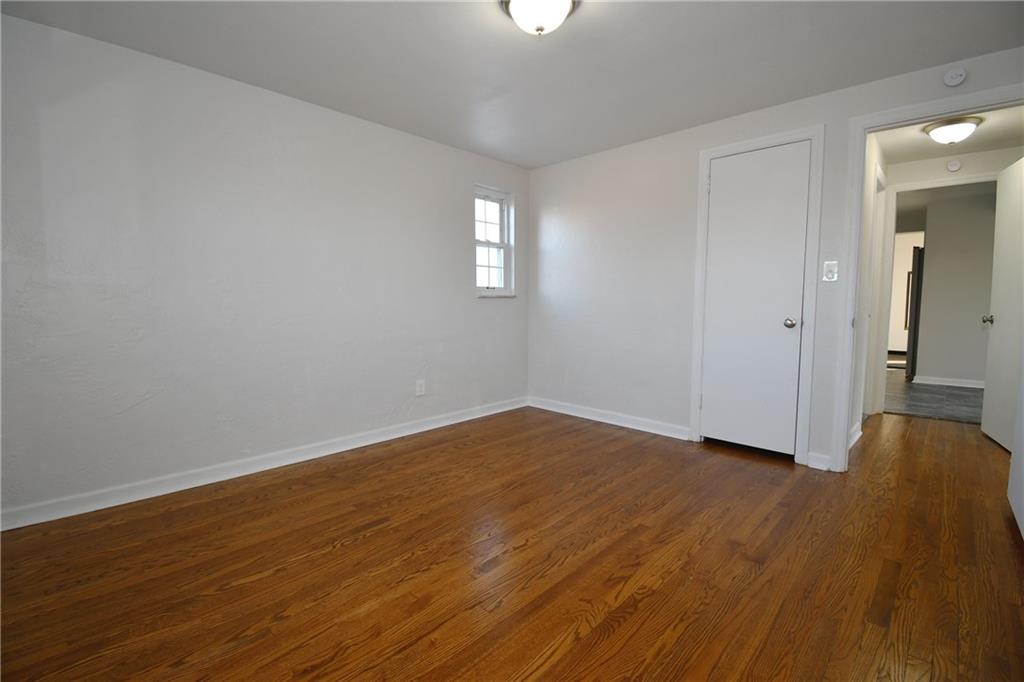 217 Oaklyn Road Bethel Park, PA 15102 - Photo 13 of 42 an empty room with wooden floor and windows