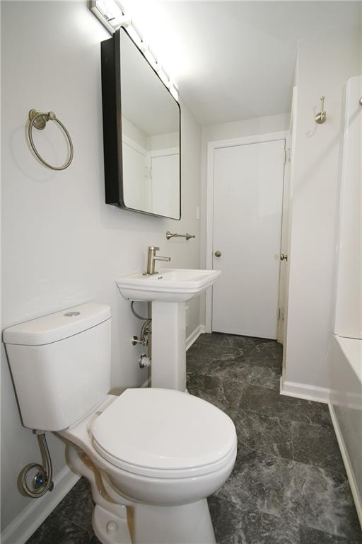 217 Oaklyn Road Bethel Park, PA 15102 - Photo 15 of 42 a bathroom with a toilet a sink and mirror